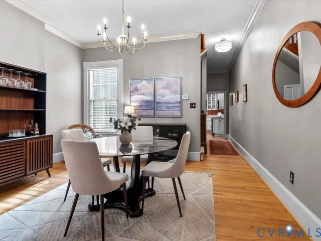 a dining room with furniture a mirror and wooden floor