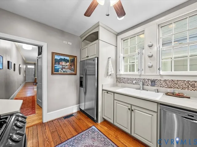a kitchen with a sink appliances and a counter top space