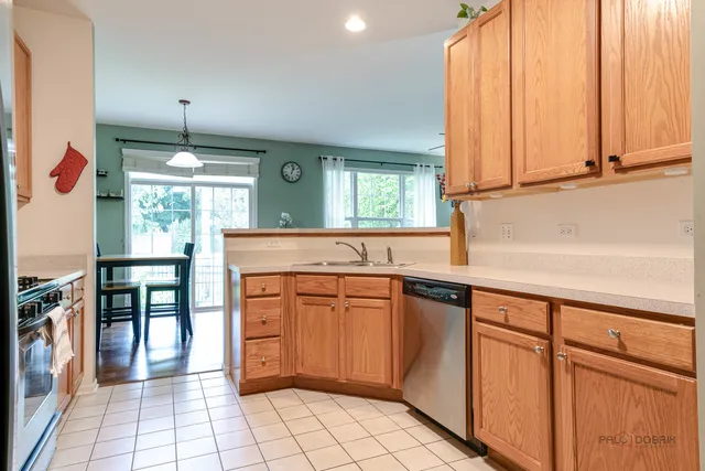 a kitchen with stainless steel appliances granite countertop a sink and cabinets
