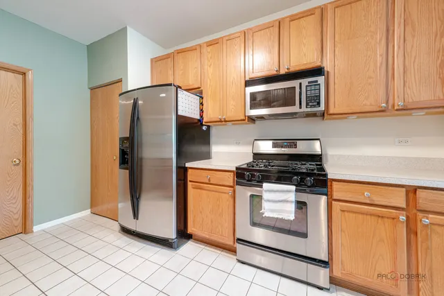 a kitchen with stainless steel appliances granite countertop a stove a refrigerator and a microwave