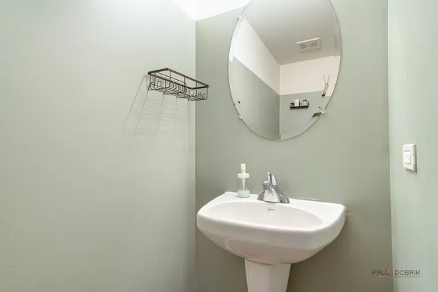 a bathroom with a sink a mirror and vanity