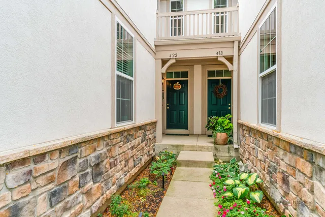 a view of an entryway with flower pots
