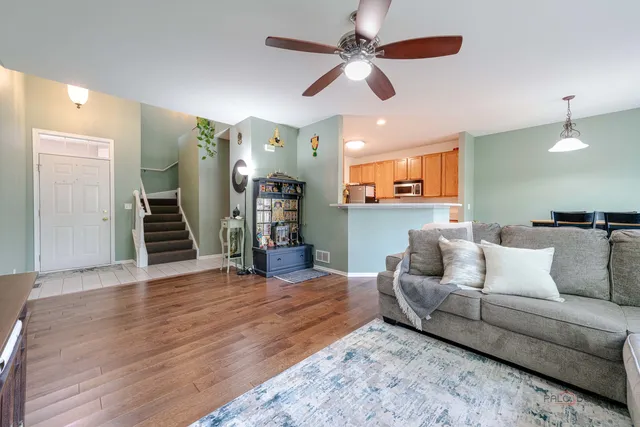 a living room with furniture and a ceiling fan