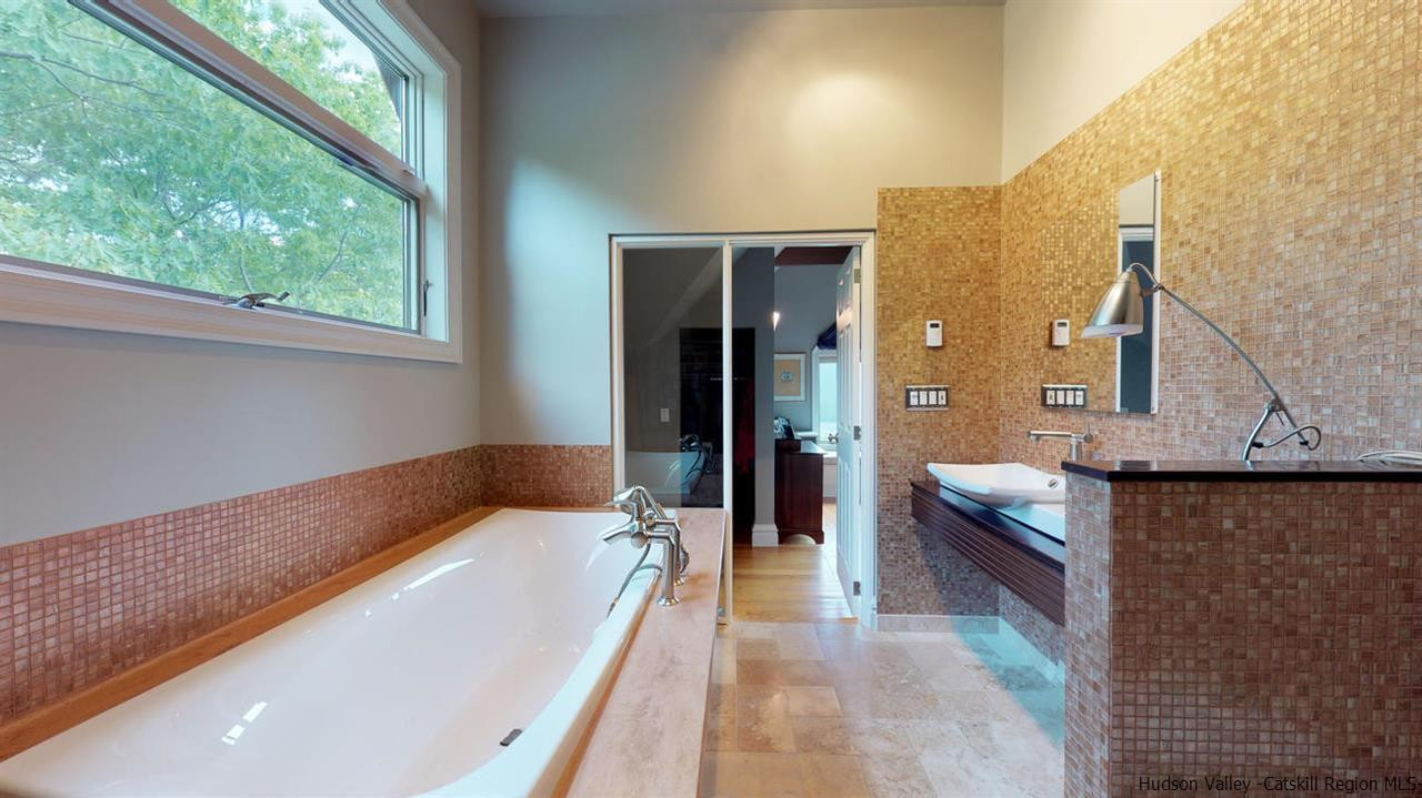 9 Torrens Hook Road, Unit DANCING ROCK Shokan, NY 12481 - Photo 16 of 23 a bathroom with a tub a sink and a large window