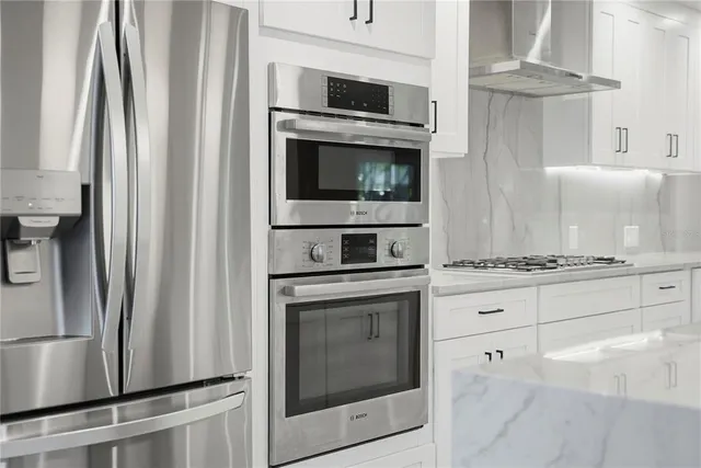 a kitchen with cabinets stainless steel appliances and a counter top space