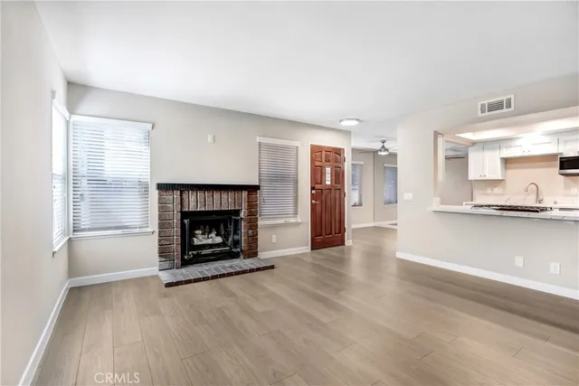 an empty room with a fireplace and window