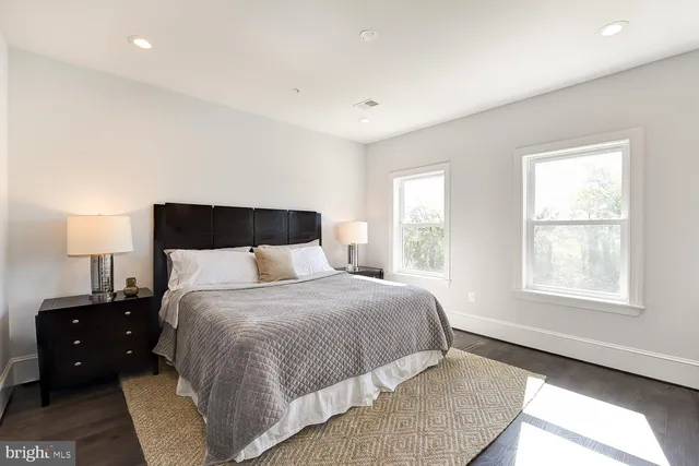 a bedroom with a bed and a night stand