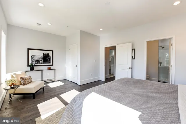 a bedroom with a bed and a couch