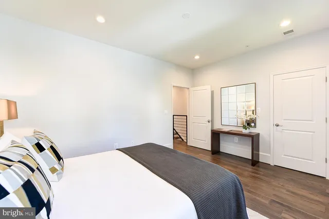 a bedroom with a bed and a desk