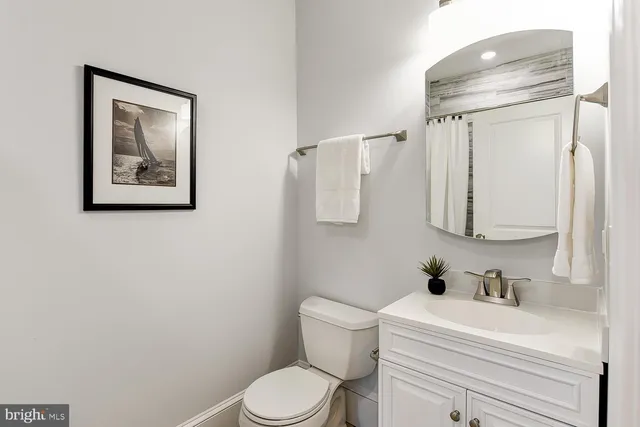a white toilet sitting next to a bathroom sink