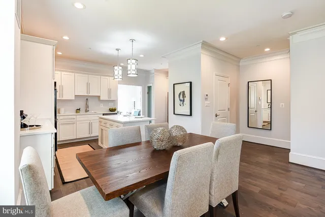 a living room with kitchen island furniture and a chandelier