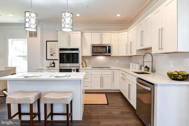 a kitchen with cabinets a sink and appliances