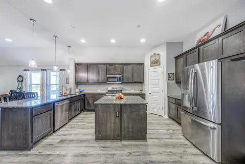 a kitchen with counter top space cabinets and stainless steel appliances