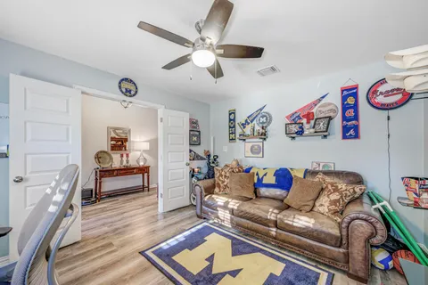 a bedroom with furniture and a mirror