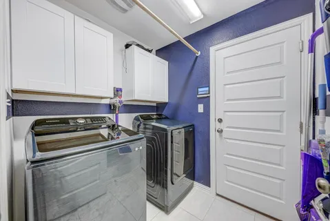 a bathroom with a granite countertop sink a toilet a mirror and shower