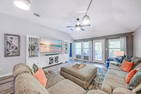 a kitchen with kitchen island granite countertop wooden floors and stainless steel appliances