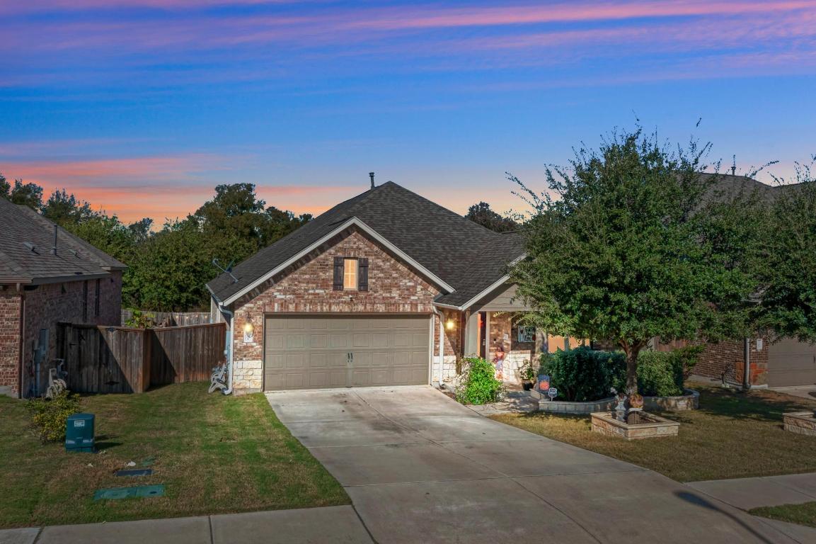 3101 Diego Cove Round Rock, TX 78665 - Photo 7 of 40 a front view of a house with a yard and garage