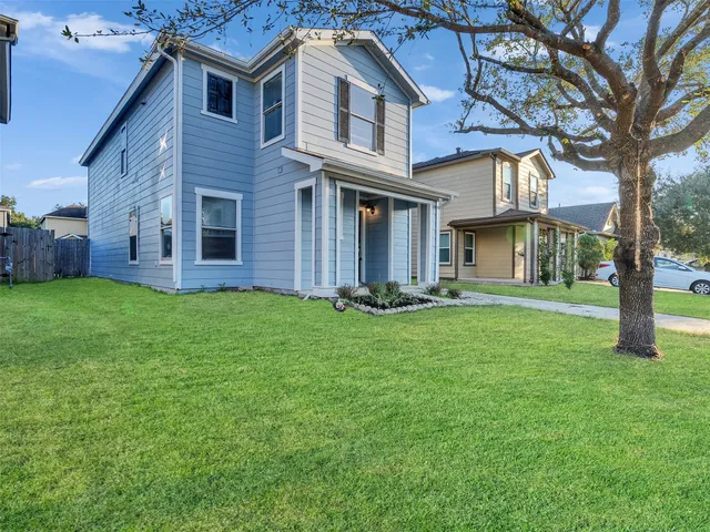 a front view of a house with a garden and yard