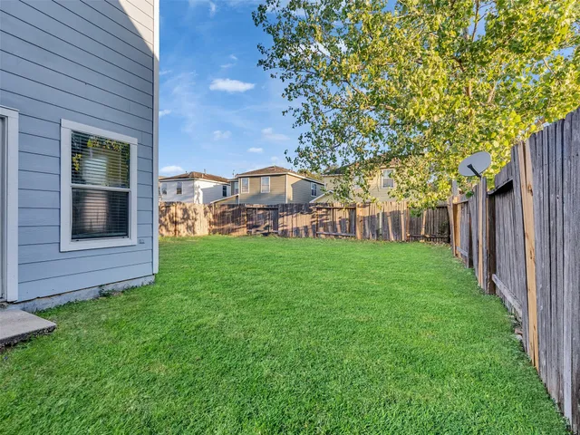 a view of a house with backyard and porch