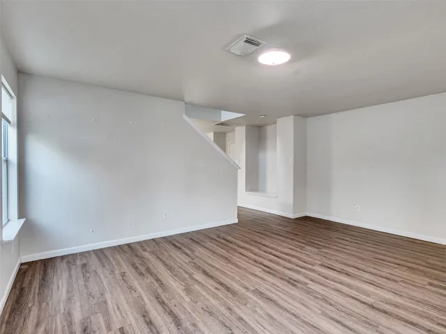 a kitchen with stainless steel appliances wooden floors and wooden cabinets