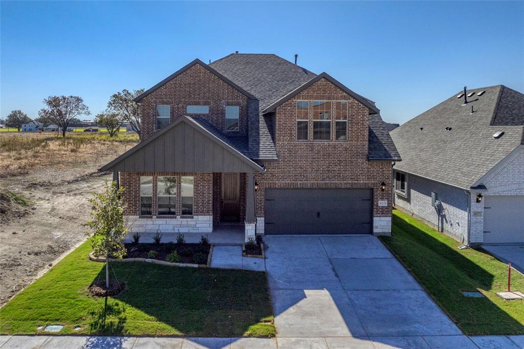 613 Brazos Drive Van Alstyne, TX 75495 - Photo 3 of 29 View of front of property featuring brick siding, a front yard, driveway, and roof with shingles