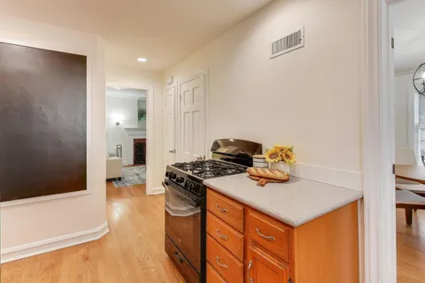 a kitchen that has a sink and a stove in it