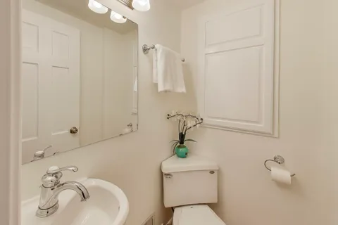 a white toilet sitting next to a bathroom sink
