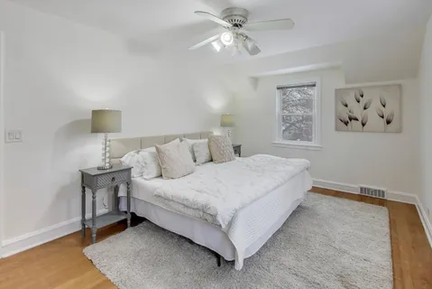 a bedroom with a bed and a night stand