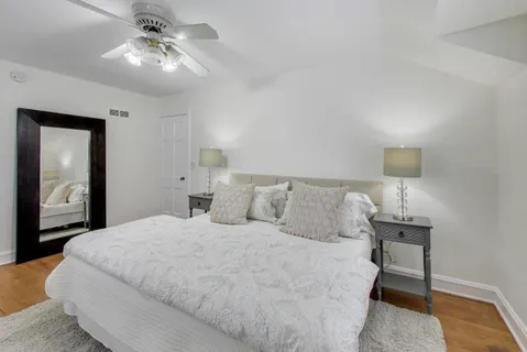 a bedroom with a bed and a lamp on table