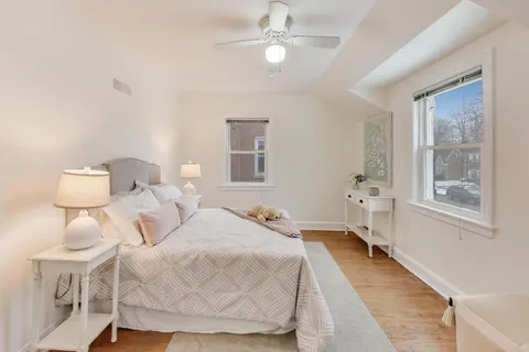 a bedroom with a bed and a chandelier