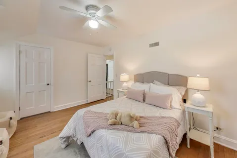 a view of a room with wooden floor and fan