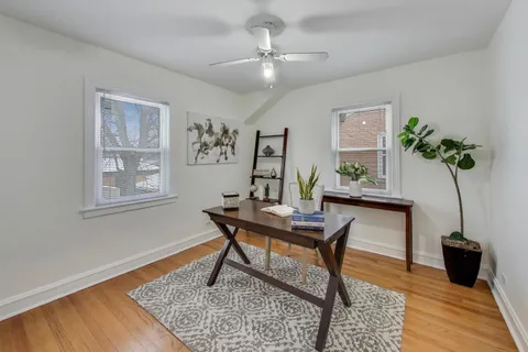 a view of a workspace with furniture and wooden floor