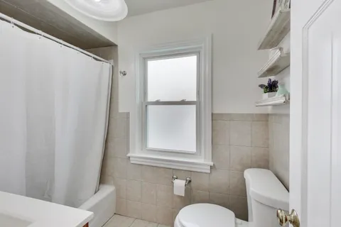 a bedroom with a large bed and a lamp