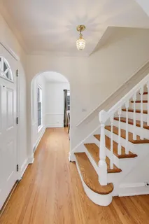 a view of entryway and hall with wooden floor