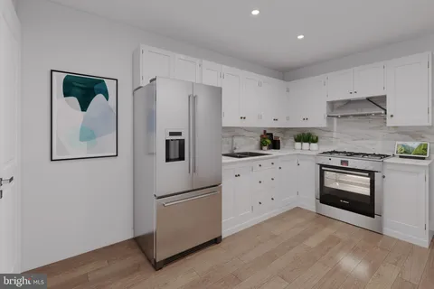 a kitchen with cabinets stainless steel appliances and wooden floor