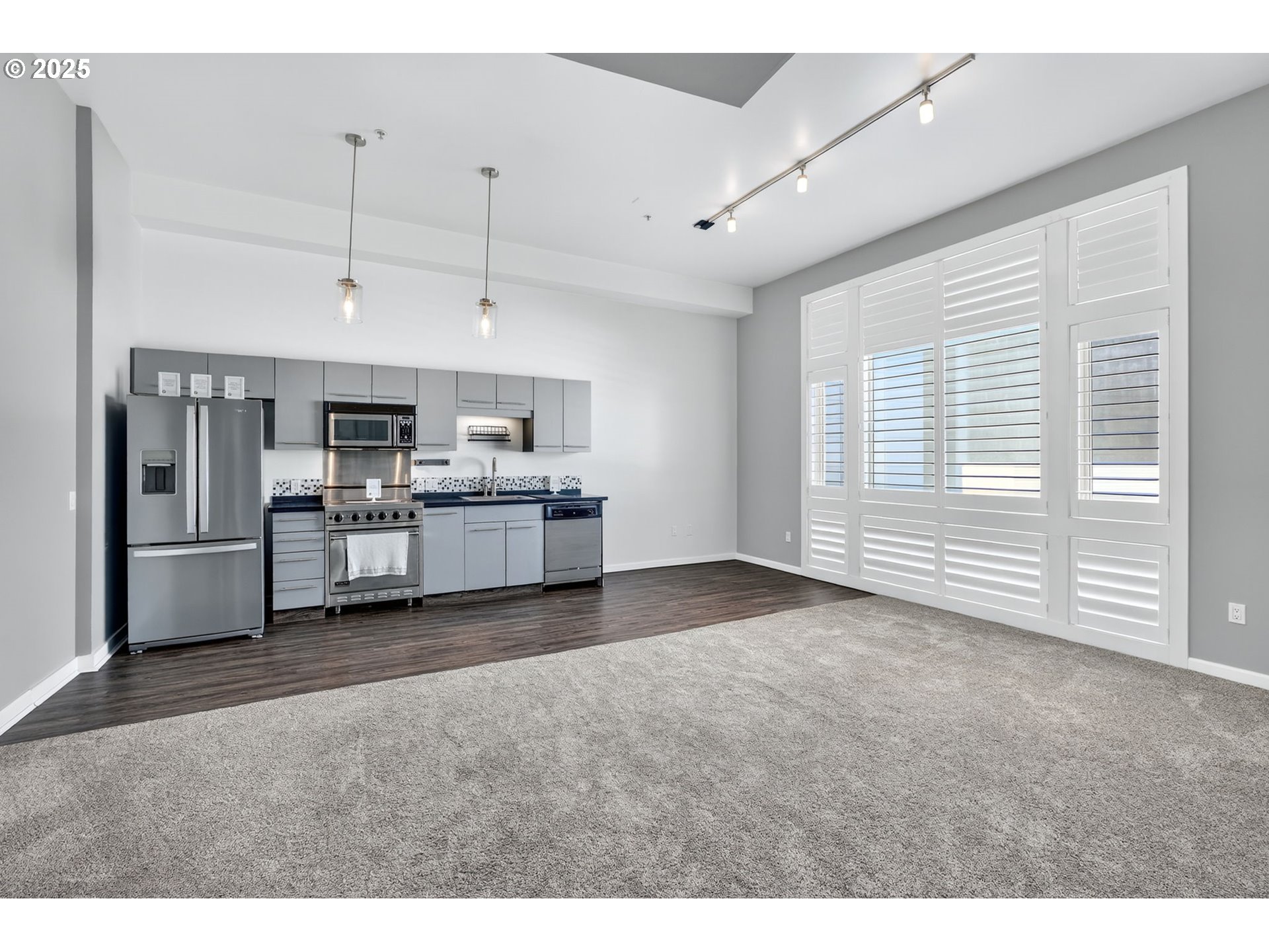 12600 Southwest Crescent Street, Unit 420 Beaverton, OR 97005 - Photo 11 of 45 a living room with stainless steel appliances kitchen island granite countertop furniture and a kitchen view