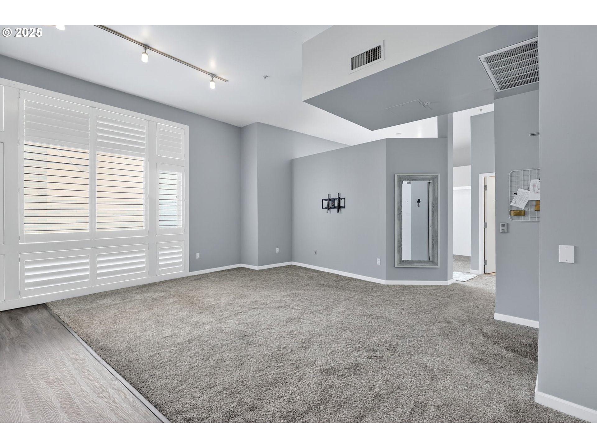 12600 Southwest Crescent Street, Unit 420 Beaverton, OR 97005 - Photo 19 of 45 a view of an empty room with wooden floor and a window