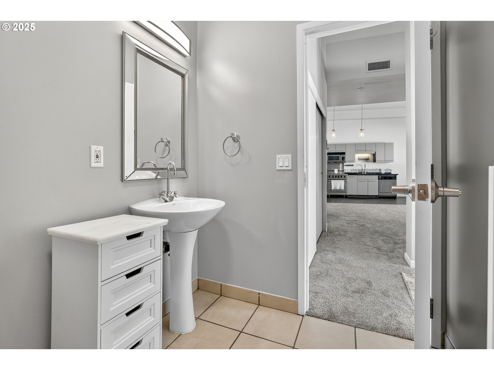 12600 Southwest Crescent Street, Unit 420 Beaverton, OR 97005 - Photo 31 of 45 a bathroom with a sink a mirror a vanity and a shower