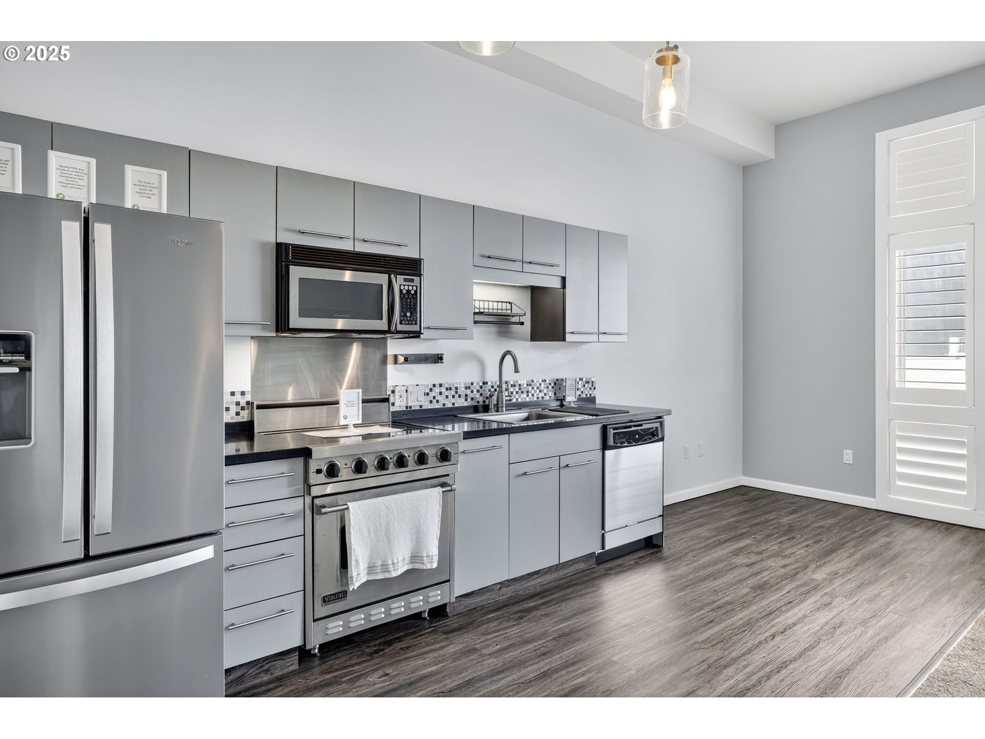 12600 Southwest Crescent Street, Unit 420 Beaverton, OR 97005 - Photo 6 of 45 a kitchen with granite countertop a refrigerator stove and microwave