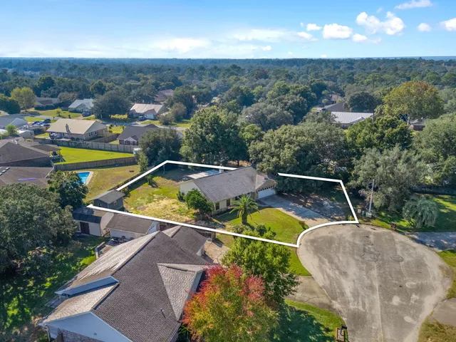 an aerial view of a house with a swimming pool