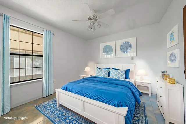 a spacious bedroom with a bed and a window