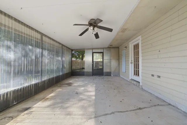 a view of a porch with wooden floor and a ceiling fan