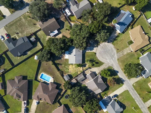 an aerial view of a house with a swimming pool