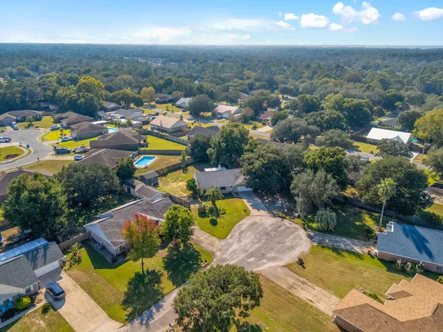 an aerial view of a house with a swimming pool yard and outdoor seating
