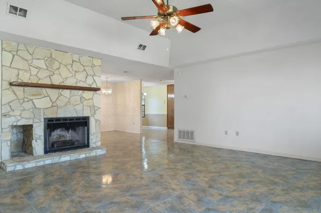 a view of an empty room with a fireplace