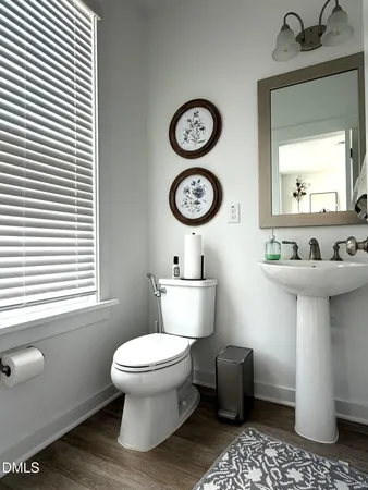 a bathroom with a toilet a sink and a mirror