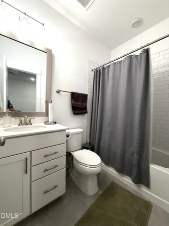 a bathroom with a sink a toilet a mirror and vanity