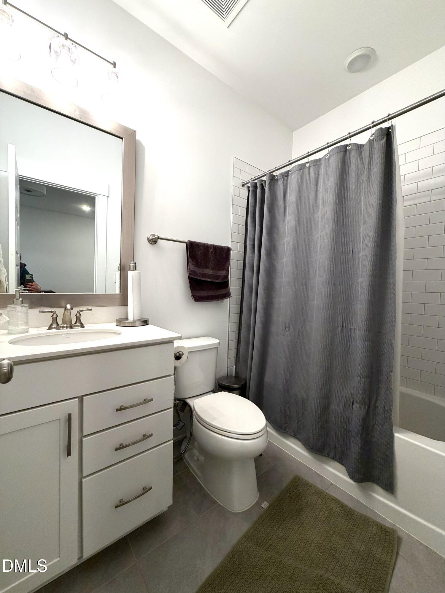 1250 Corkery Ridge Court Cary, NC 27519 - Photo 19 of 31 a bathroom with a sink a toilet a mirror and vanity