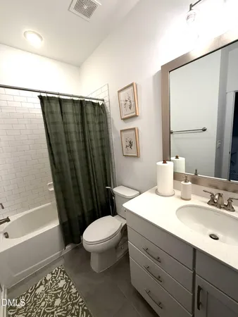 a bathroom with a sink a toilet a shower a vanity and mirror