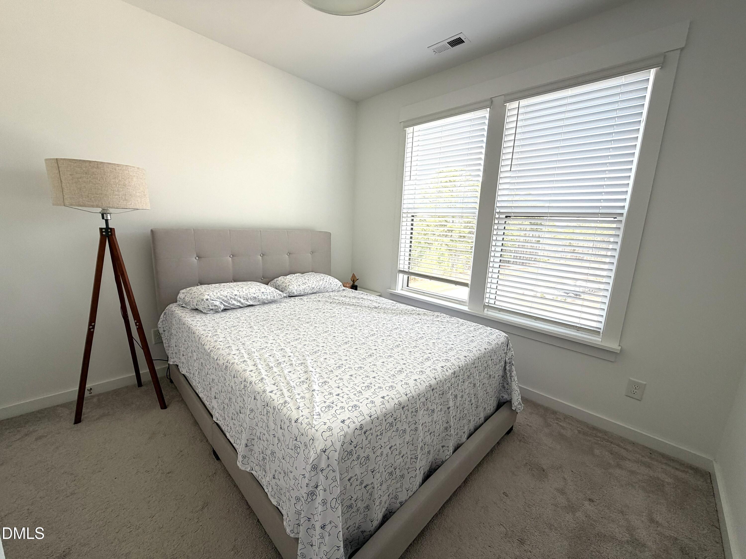 1250 Corkery Ridge Court Cary, NC 27519 - Photo 24 of 31 a bed sitting in a bedroom next to a window